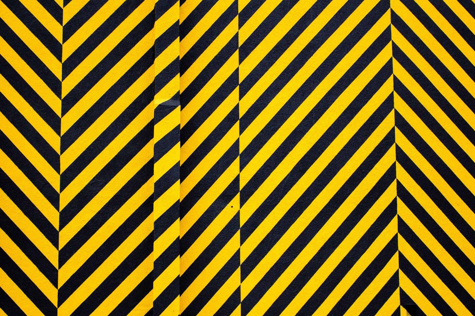 A wall panted with diagonal black and yellow stripes